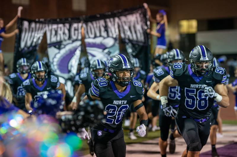 Downers Grove North players take the field against Downers Grove South during player introductions at Downers Grove North High School on Friday, Sep 9, 2022.