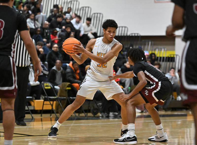 Joliet West's Ethan Hillsman (32) looks to make a play during a conference game against Plainfield North on Friday, Dec. 20, 2024, at Joliet.