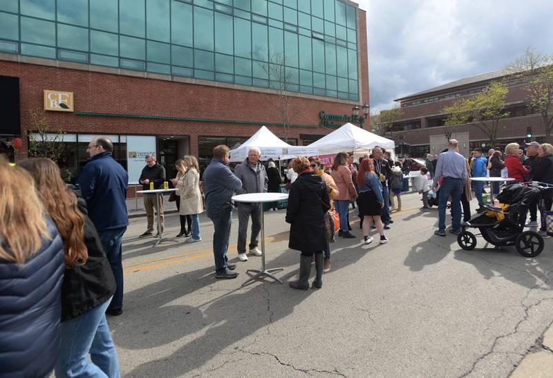 People attend the Umbrella Sky Opening Day Party in Elmhurst Saturday April 29, 2023.