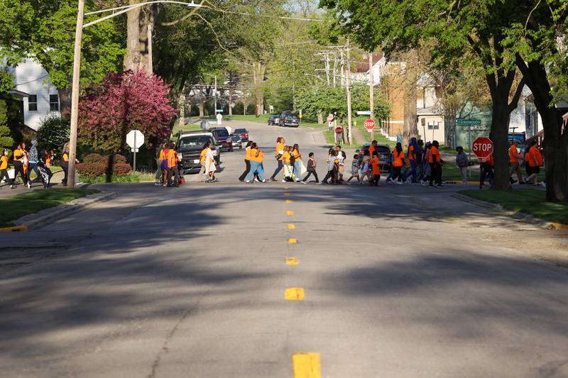 About 100 participants walk through Kankakee during the 2nd Walk Against Gun Violence on Tuesday, April 29, 2025.