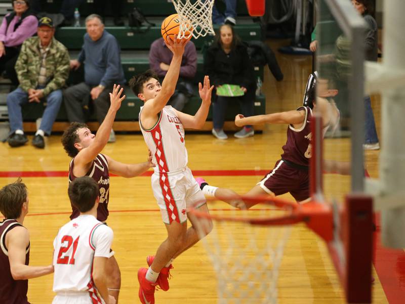 L-P's Erick Sotelo runs in for a layup over Morris's Colin Pfeifer on Friday, Dec. 6, 2024 in Sellett Gymnasium at L-P High School.