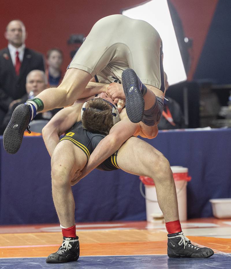 Newman’s Briar Ivey is flipped over by Riverdale’s Blake Smith in the 157 pound weight class of the 1A state individual wrestling finals Saturday, Feb. 22, 2025, at State Farm Center in Champaign.