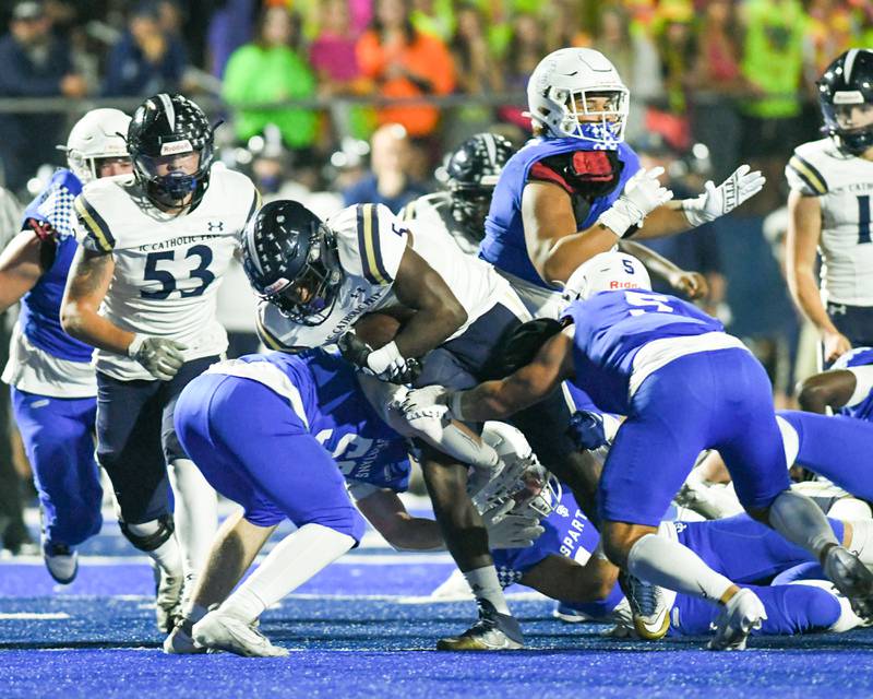 IC Catholic Prep Aaron Harvey (5) gains some yards in the first quarter before being tackled by St. Francis players on Friday Sep. 29, 2023, held at St. Francis high school in Wheaton.