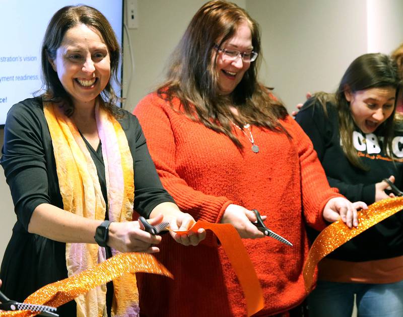Jessica Marcellis-Montavon, (left) DeKalb School District 428 Transition Program teacher and vocational coordinator, along with other teachers in the program cut the ribbon Wednesday, Jan. 22, 2025, during the grand opening celebration of the Beyond One Barb Transition Center in DeKalb. The the transition program has been in place to facilitate students with intellectual and developmental disabilities aged 18-22 into adulthood and independent living.