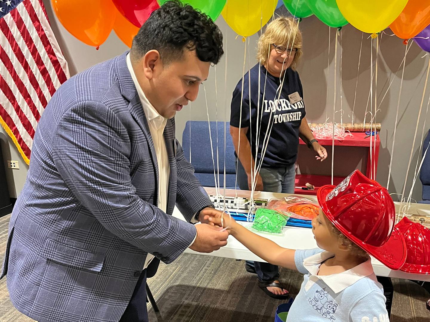 Township Supervisor Alex Zapien greets a student at the school supply fair July 17.