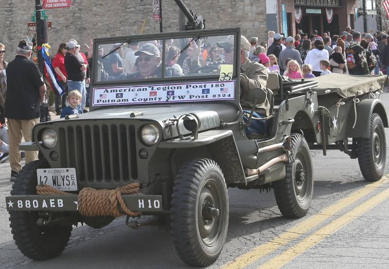 American Legion Post 180 and Putnam County VFW Post 8324 Veterans ride in a Army Jeep during the 16th annual Utica Veterans Parade and Air Show on Sunday Nov. 5, 2023 downtown Utica.
