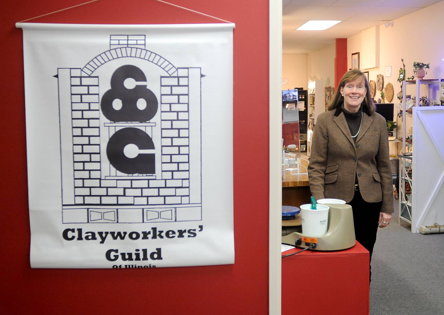 Anne Marie Whitmore Lenzini, the president of the Clayworkers' Guild of Illinois, inside the guild's new Artisans on Main gallery on Thursday, March 10, 2022. The Clayworkers' Guild of Illinois recently moved out of the Old Courthouse and Sheriff’s House in Woodstock to a new gallery and workshop space at 220 Main St.