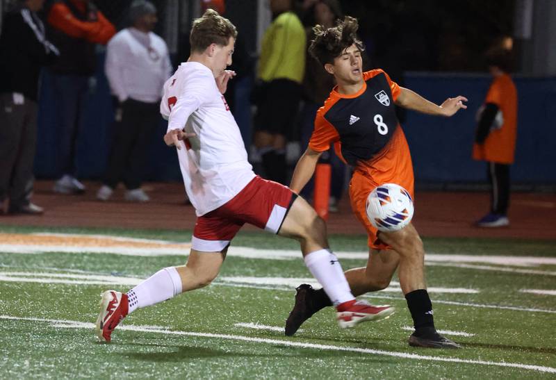 Hinsdale Central's Austen Szurgot kicks the ball away from Hersey's Teddy Reyes Friday, Nov. 8, 2024, during their Class 3A state semifinal game at Hoffman Estates High School.