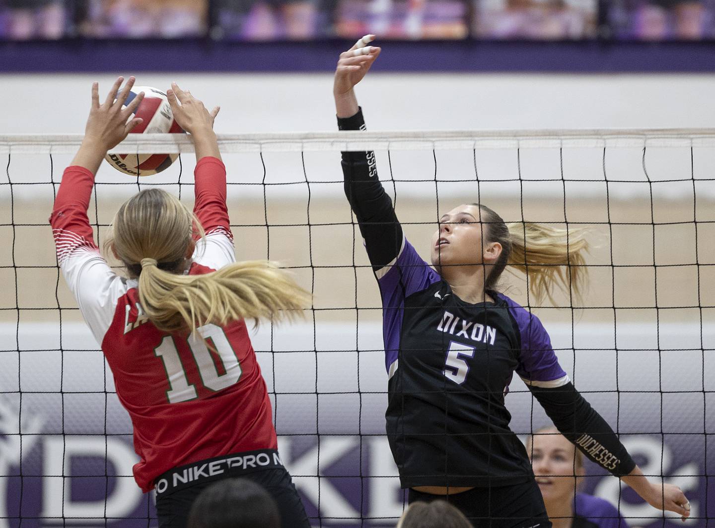 LaSalle-Peru’s Kelsey Frederick works the net against Dixon’s Morgan Hargrave Wednesday, Sept. 10, 2025.