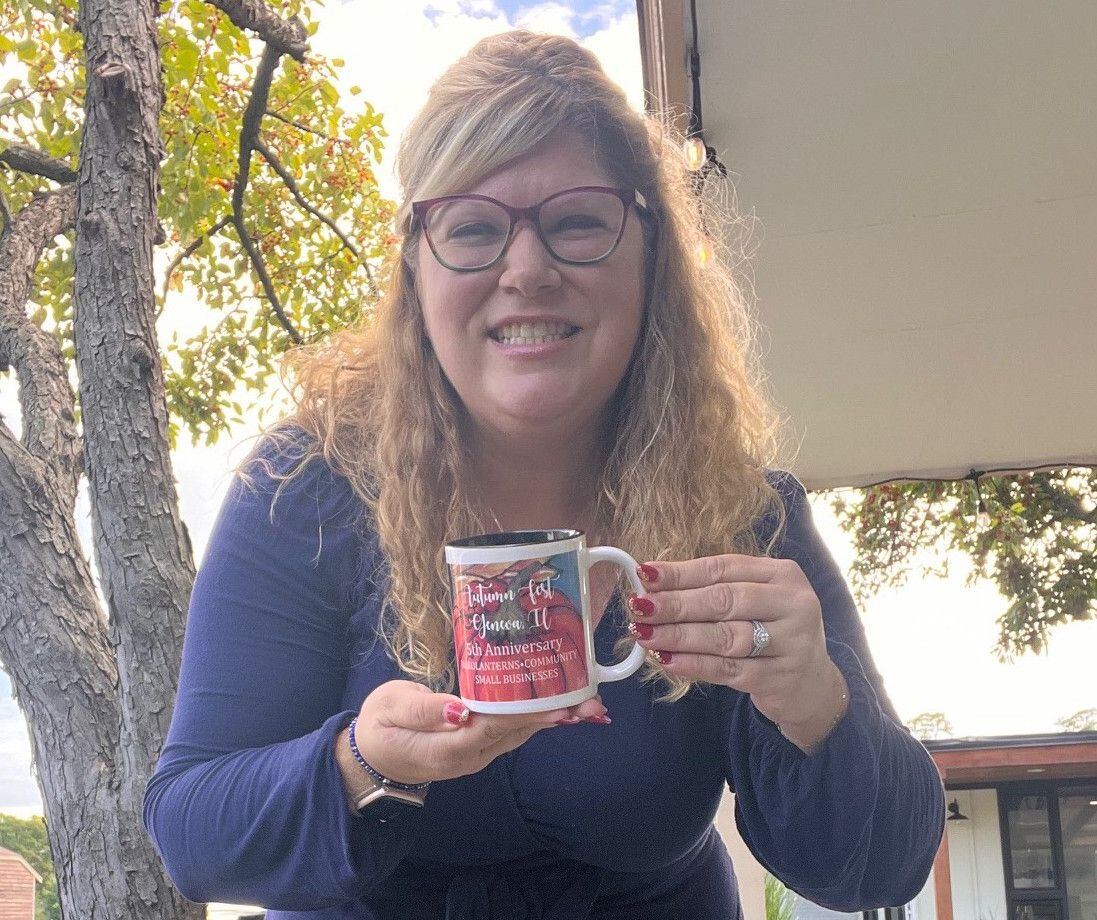 Kristen Cornelio, organizer of the self-guided Jack-O’-Lantern Walk in downtown Geneva with the event mug designed by Patty Donahue the owner of Image Awards, Engraving & Creative Keepsakes Inc. The fifth anniversary of the interactive event is scheduled for 5 to 8 p.m. Oct. 6 in downtown Geneva with 76 participating businesses.