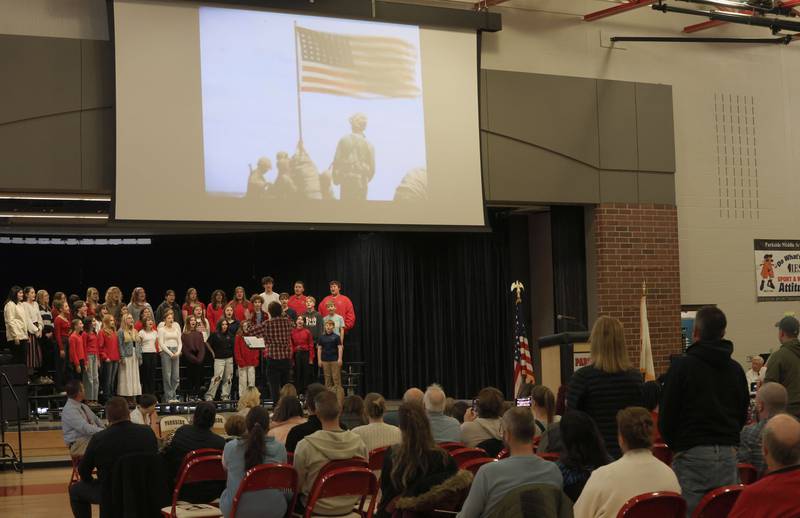 Members of the Parkside Middle School 7th and 8th grade choir perform "America Heros, an Armed Forces Salute" as Veterans stand to be recognized during the Veterans Day program on Tuesday, Nov. 11, 2025 in Peru.