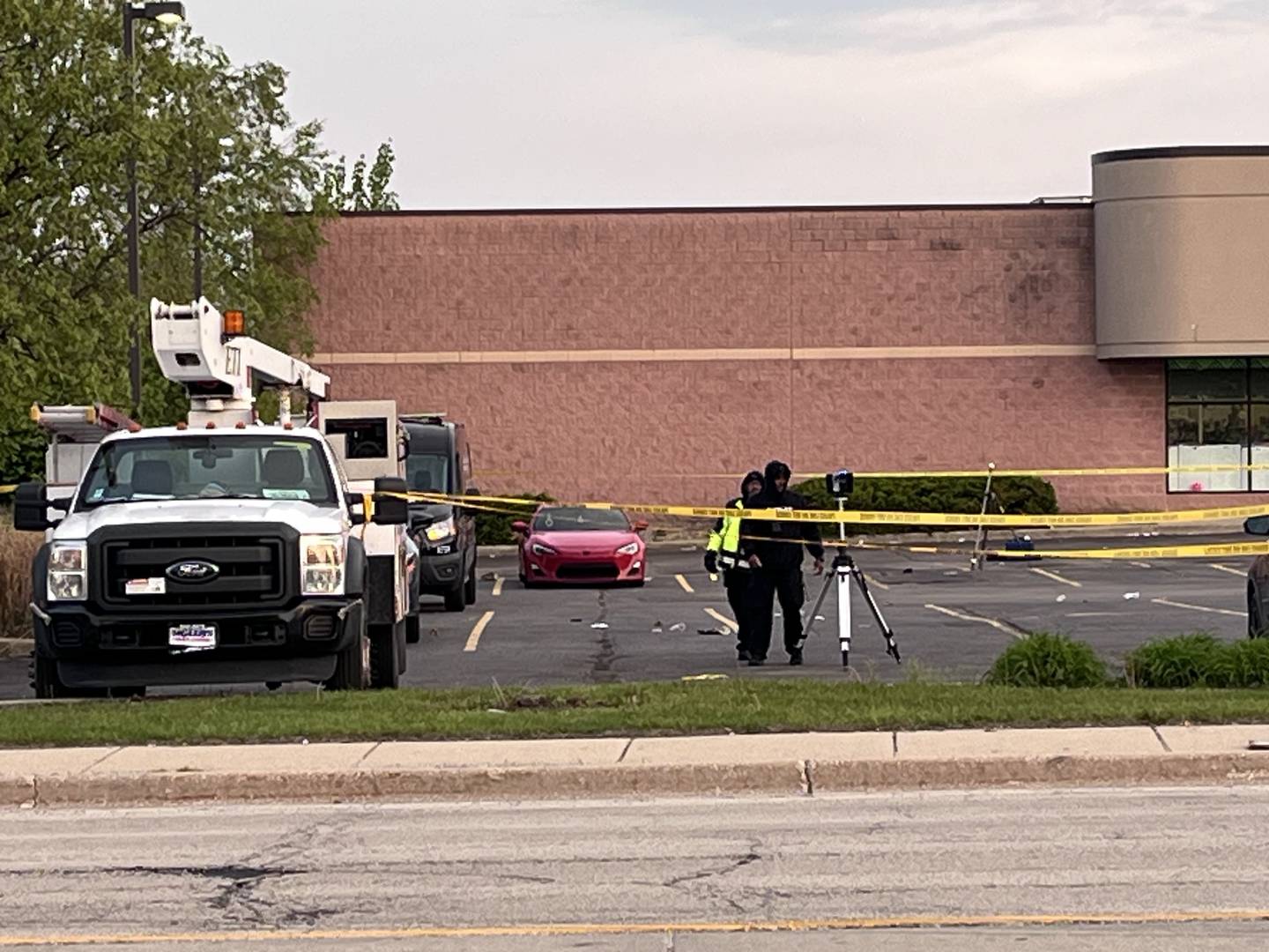 Crime scene investigators in the parking lot of Dollar Tree and Osaka restaurant near the Louis Joliet Mall area on Sunday, May 3, 2026.