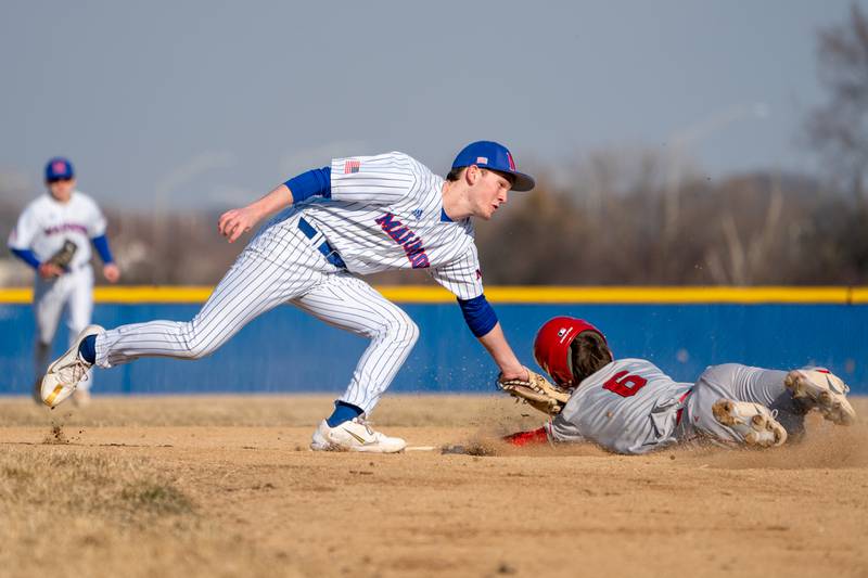 Marmion's Luke O'Connor (4) tags Yorkville's Kyle Munch (6) for an out on a steal attempt during a baseball game at Marmion High School in Aurora on Tuesday, Mar 28, 2023.