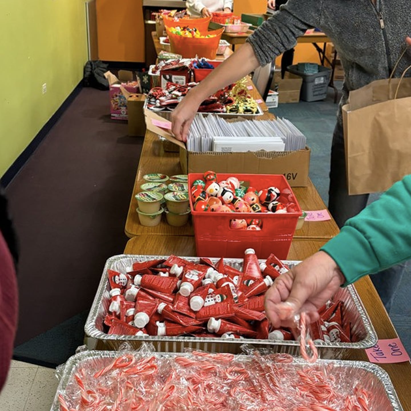 Volunteers fill gift bags with holiday treats for seniors during the Cary Park District's Holiday Party in a Bag program on Dec. 22, 2025.
