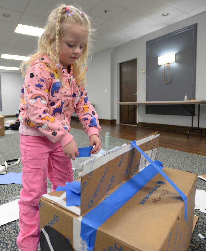 Caoimhe Shields of LaGrange finishes putting her car together during the Drive In Movie event held at the Park District of La Grange Friday, Feb 23, 2024.