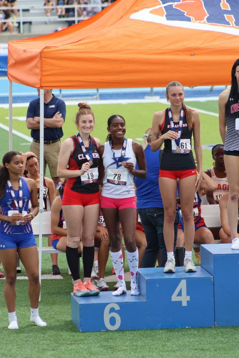 Ohio senior Jillian Anderson takes her spot on the awards stand with a sixth-place medal in the high jump for the Amboy co-op.