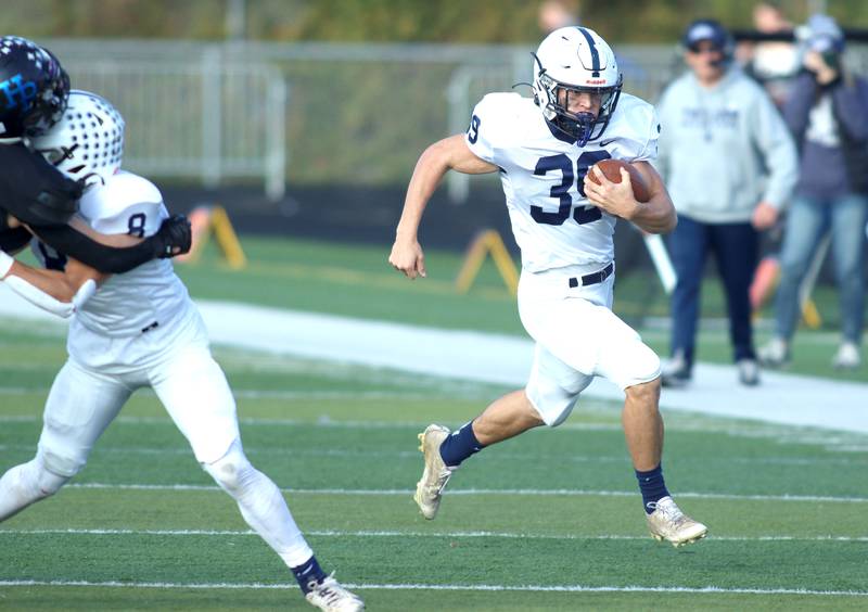 Cary-Grove’s Holden Boone runs the ball against Highland Park in second-round IHSA Class 6A playoff action at Wolters Field in Highland Park Saturday.