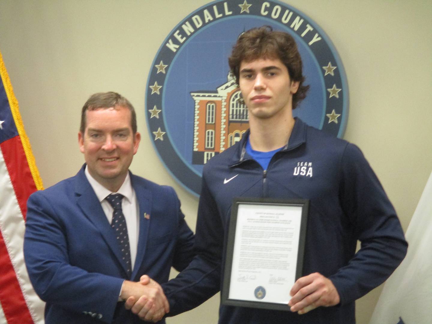 Kendall County Board Chairman Scott Gryder presents Yorkville judo champion Alex Knauf with honors for his athletic success during the Sept. 20, 2022 regular meeting.