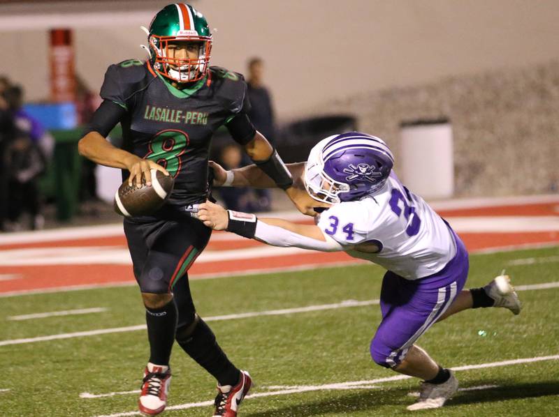 L-P quarterback Marion Persich avoids a sack from Rochelle's Brandyn Metzger on Friday, Sept. 27, 2024 at Howard Fellows Stadium.