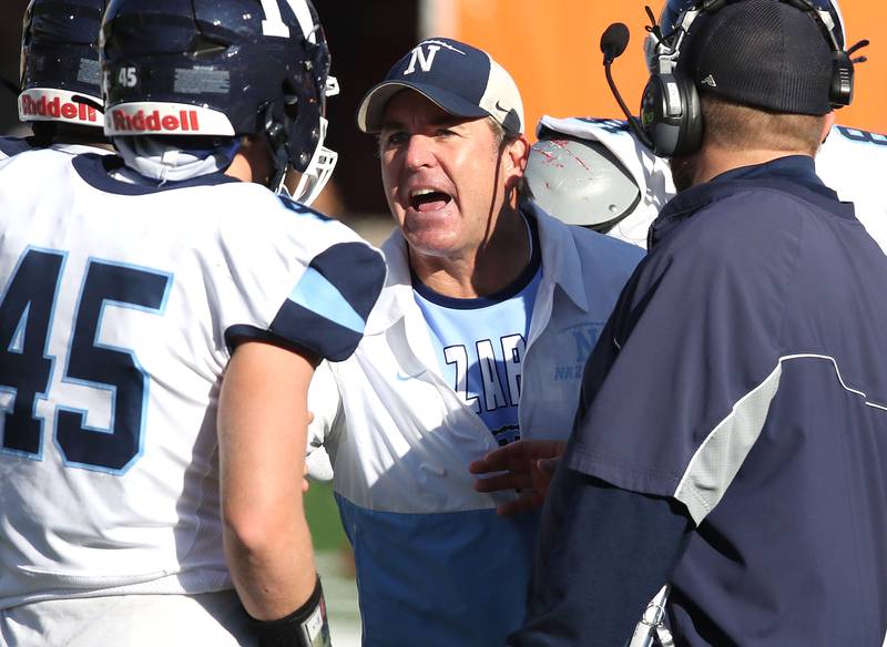 Nazareth's head coach Tim Racki talks to his players during their IHSA Class 5A state championship game against Peoria Saturday, Nov. 26, 2022, in Memorial Stadium at the University of Illinois in Champaign.