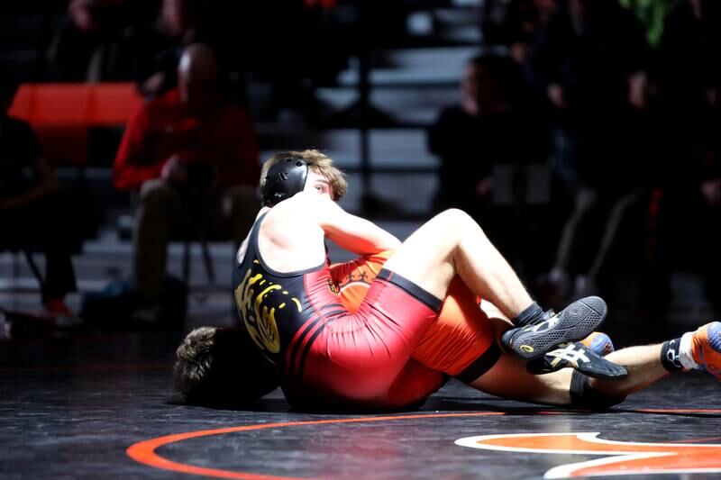 Batavia’s Kyle Pasco looks over his shoulder during a match against St. Charles East’s Gavin Woodmancy in the 126-pound weight class during a dual meet in St. Charles on Thursday, Jan. 4, 2024.
