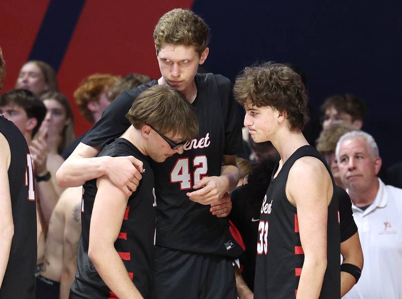 Benet players console each other as time ticks away Saturday, March 14, 2026, in their IHSA Class 4A state championship loss to Marist in the State Farm Center at the University of Illinois in Champaign.