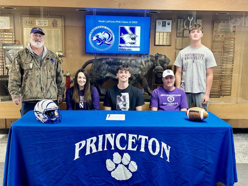 Princeton Class 3A senior all-stater Noah LaPorte signs to play for the Northwestern Wildcats Wednesday afternoon at Prouty Gym. He was joined by his signing by his grandfather, Bob LaPorte, Jr.,, his mother, Kristin Wright, his father, Bob LaPorte, and his brother, Luke.