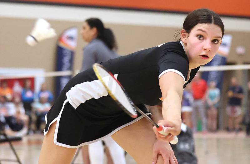 DeKalb’s Gwen Pfile hits a backhand Friday, May 12, 2023, during her match against  	Carissa Chen from the Illinois Math and Science Academy in the IHSA State Badminton Finals at DeKalb High School.
