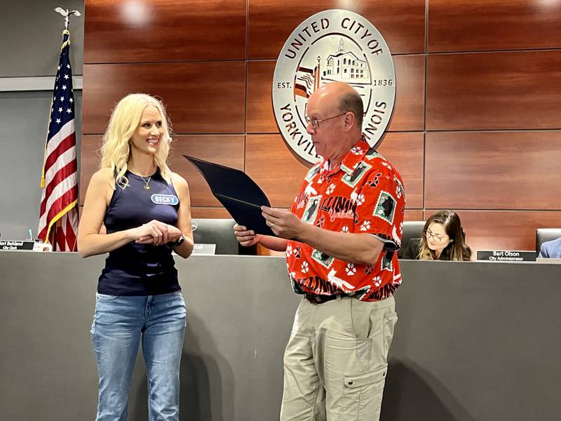 Yorkville resident Becky Lenski receives a special certificate of recognition from Mayor John Purcell following her winning-performance on the game show Wheel of Fortune.