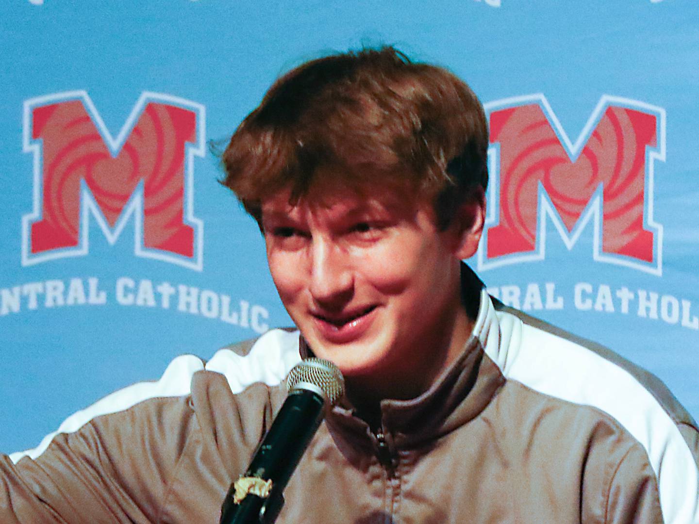 Christian Bentancur, flanked by his father, Patrick, grabs the Clemson cap as he announces Friday, Jan. 13, 2023, that he will attend Clemson University to play Division I football, at Marian Central High School. Bentancur, a highly recruited tight-end, narrowed his section down to Clemson from his final three colleges. The other two colleges were Ohio State and Oregon universities.