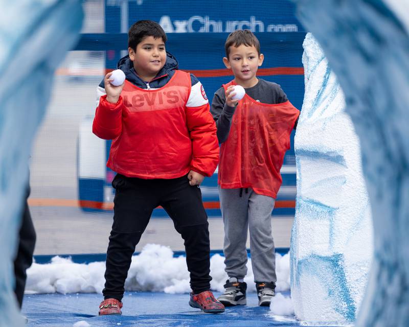 Children look to throw "snowball's" the annual 'Ax Church Ultimate Snowball Fight' at Frosty on First on Saturday, November 8, 2025 on First Street in La Salle.