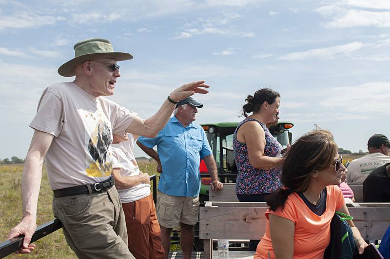 Volunteer Don Panozzo educates a group of tourists who are checking out a herd of bison on Saturday at the Nachusa Grasslands’ annual Autumn on the Prairie.