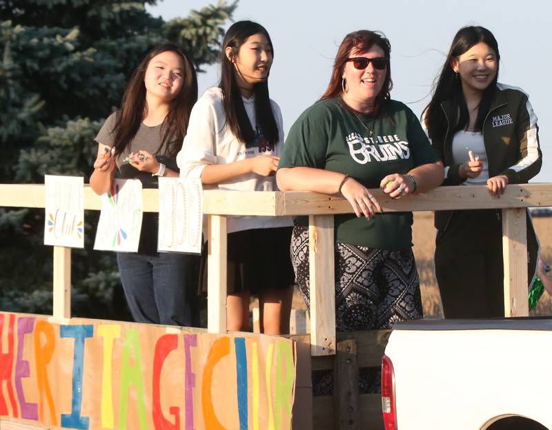 Members of the St. Bede heritage club ride in the St. Bede Homecoming Parade on Friday, Sept. 29, 2023 at St. Bede Lane.