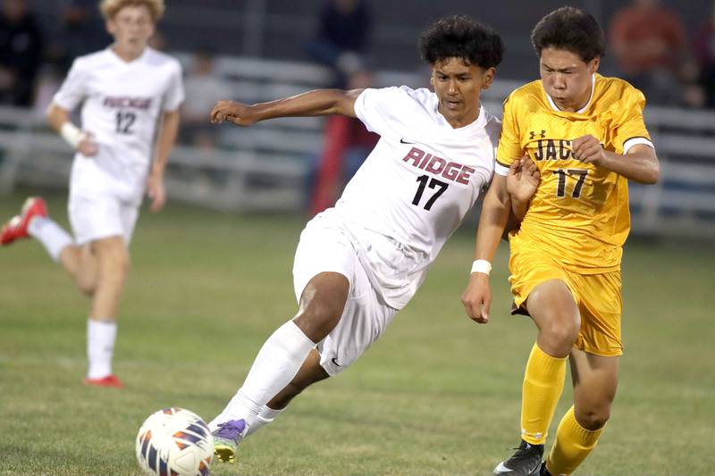 Jacobs’ Elnur Kaziev, right, battles Prairie Ridge’s Noe Lopez in varsity soccer at Jacobs High School in Algonquin on Thursday, Sept. 18, 2025.