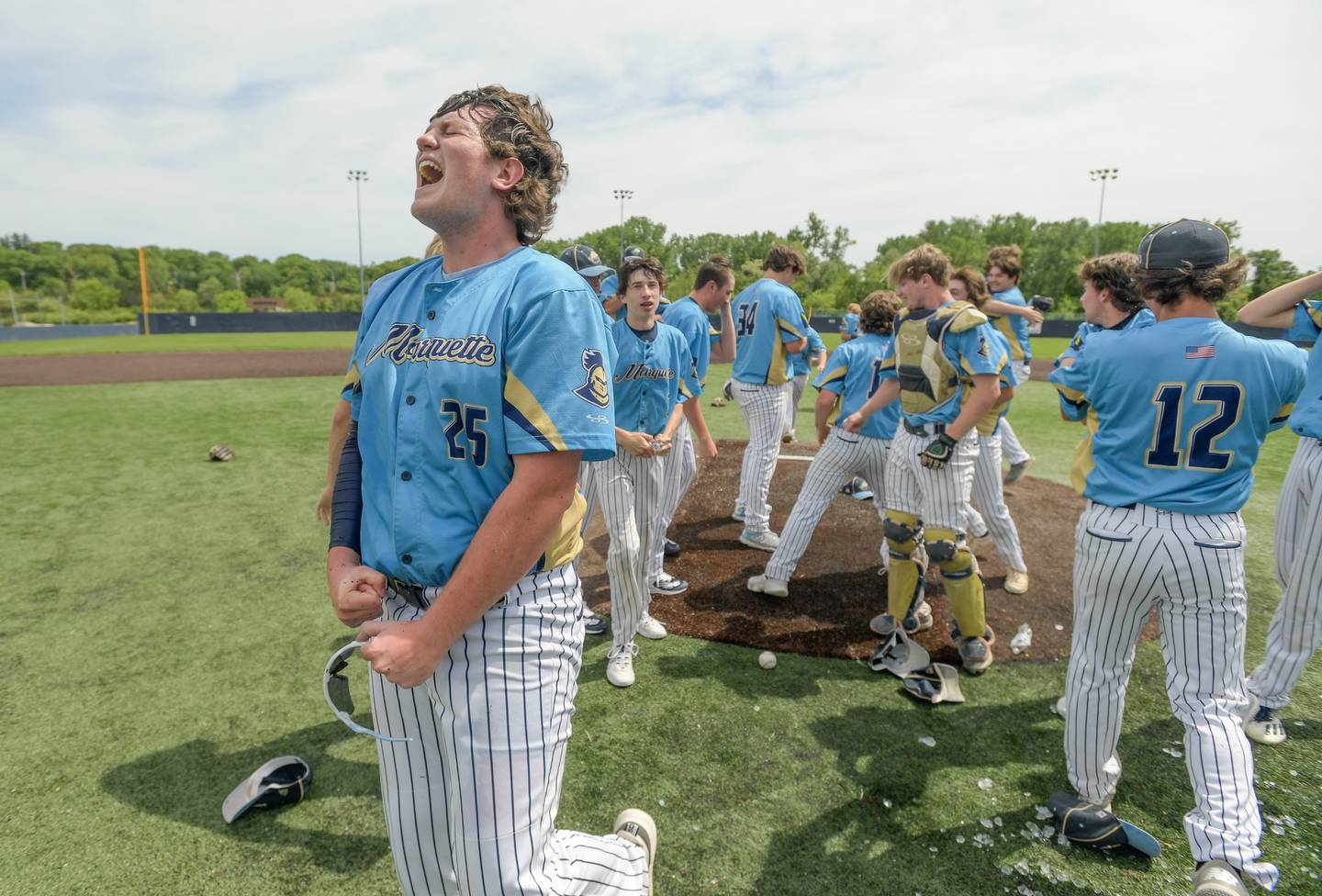 Marquette's winning pitcher Aidan Thompson (25) celebrates his teams victory over Putnam County for the Baseball 1A Harvest Christian Sectional title at Judson College in Elgin on Saturday, May 28, 2022.