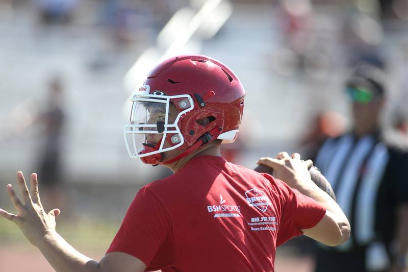 Yorkville quarterback Kyle Stevens looks for a receiver during a 7 on 7 tournament at St. Charles North High School on Thursday, June 30, 2022.