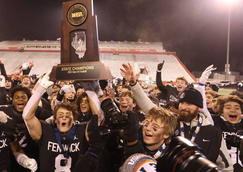 Members of the Fenwick football team hoist the Class 6A State championship trophy on Tuesday, Dec. 2, 2025 in Hancock Stadium at Illinois State University in Normal.