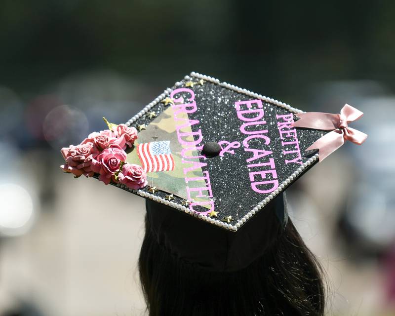 A DeKalb High School graduate wears a cap that reads “Pretty educated and graduated” as she gathers with friends and family after the graduation ceremony on Saturday May 23, 2026, held at the Convocation Center in DeKalb.