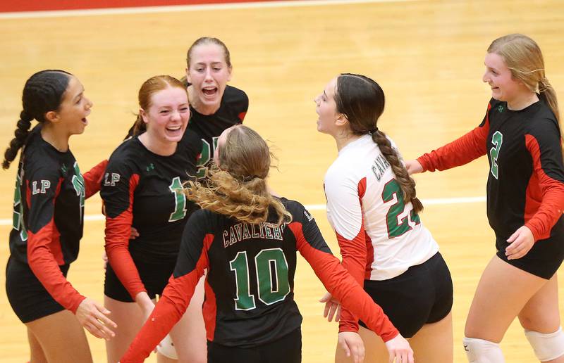 Members of the L-P volleyball team react after knocking off Ottawa in two-sets on Thursday, Sept. 21, 2023 at Kingman Gym.