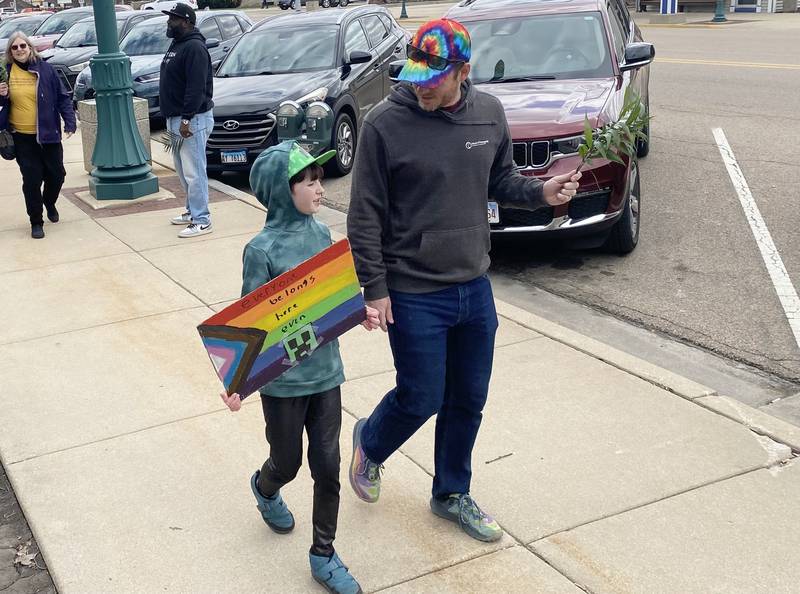 Participants hold signs during a procession at a Palm Sunday Faith Action event on Sunday, March 29, 2026, in front of the DeKalb County Courthouse in Sycamore. Area Christian ministers organized the event to combat the rise of Christian nationalism in the U.S.
