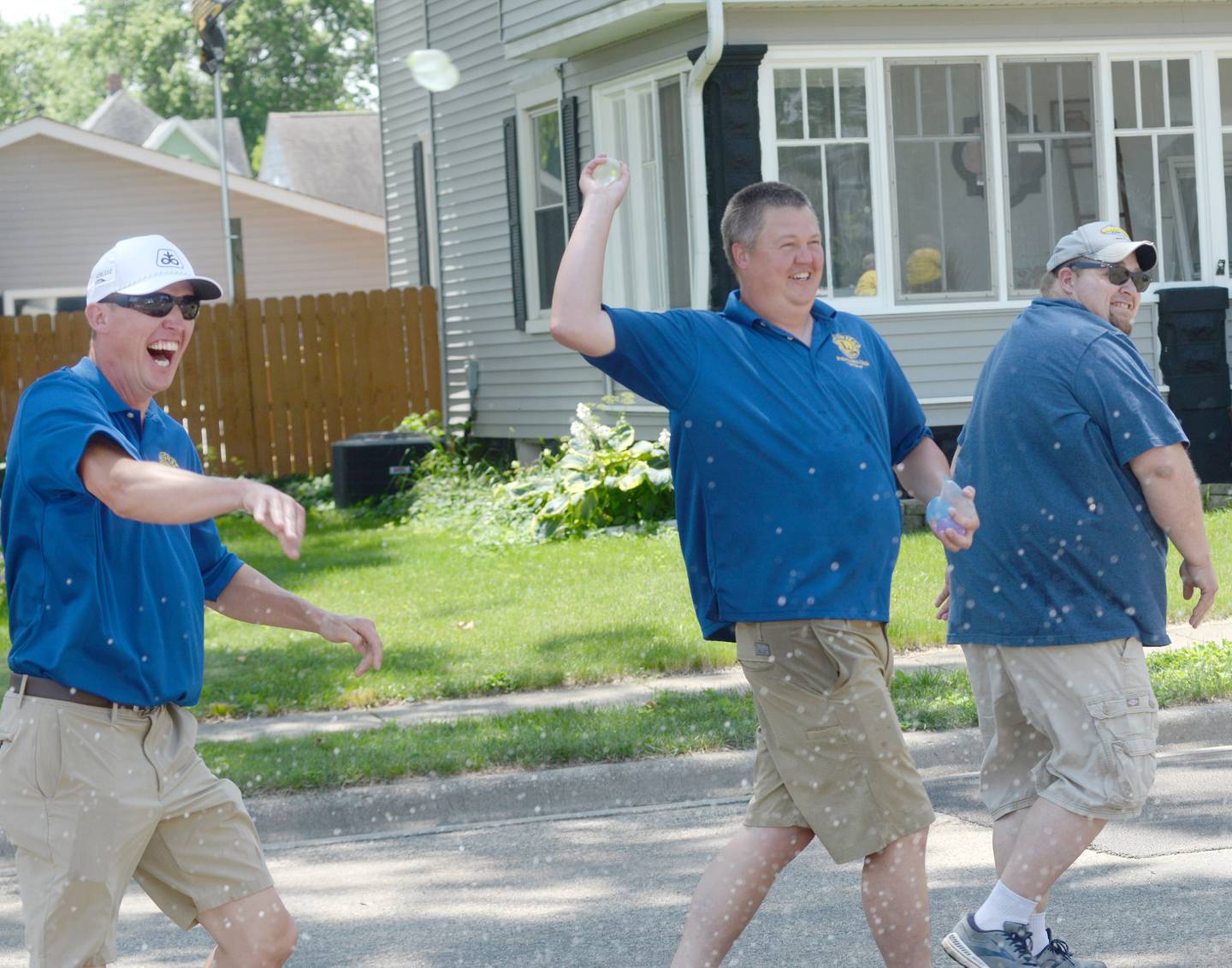 Polo Lions Club members toss water balloons at Billie Quaco as they walk past her home during the Town & Country Days Parade on Sunday, June 29, 2025.