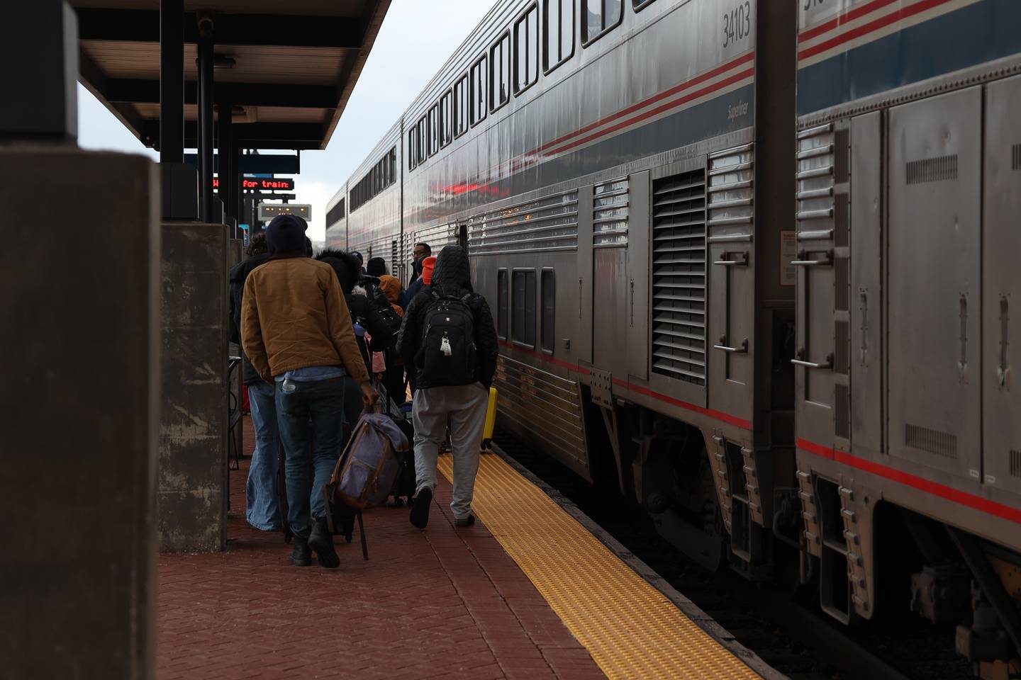 Pedestrians board an Amtrak train at the Joliet Gateway Center train station on Wednesday, Jan. 3rd, 2024 in Joliet.