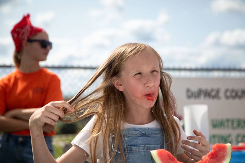 Pepper Rozylowicz, 11, fixes her hair during the in the DuPage County Fair's Watermelon Eating Contest at the DuPage Event Center & Fairgrounds on Saturday, July 30, 2022.