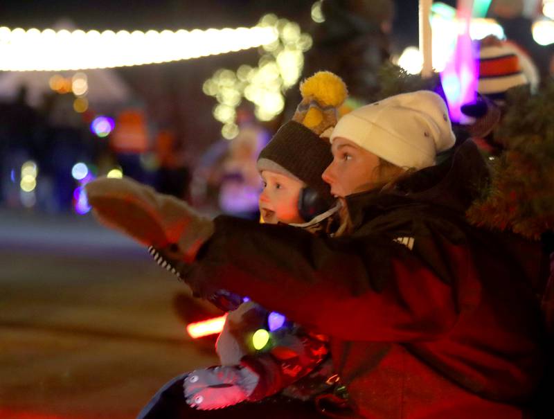 Maggie Mueller of Crystal Lake watches with her nephew Zach Kratenstein, 5, during the Festival of Lights Holiday Parade in downtown Crystal Lake on Fariday, Nov. 29, 2024.