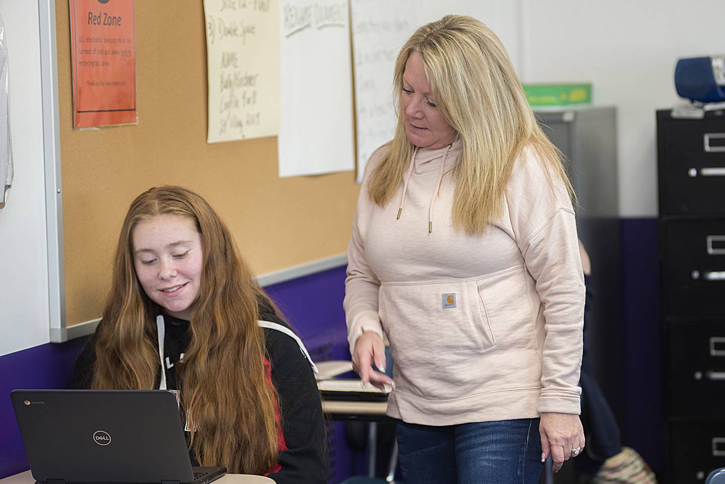 Dixon High School teacher Jenny Kirchner works on a project with student Autumn Sandusky Thursday, April 14, 2022. Kirchner has dedicated the past 32 years to educating the students of Dixon public schools. Her love of teaching stretches back even further.