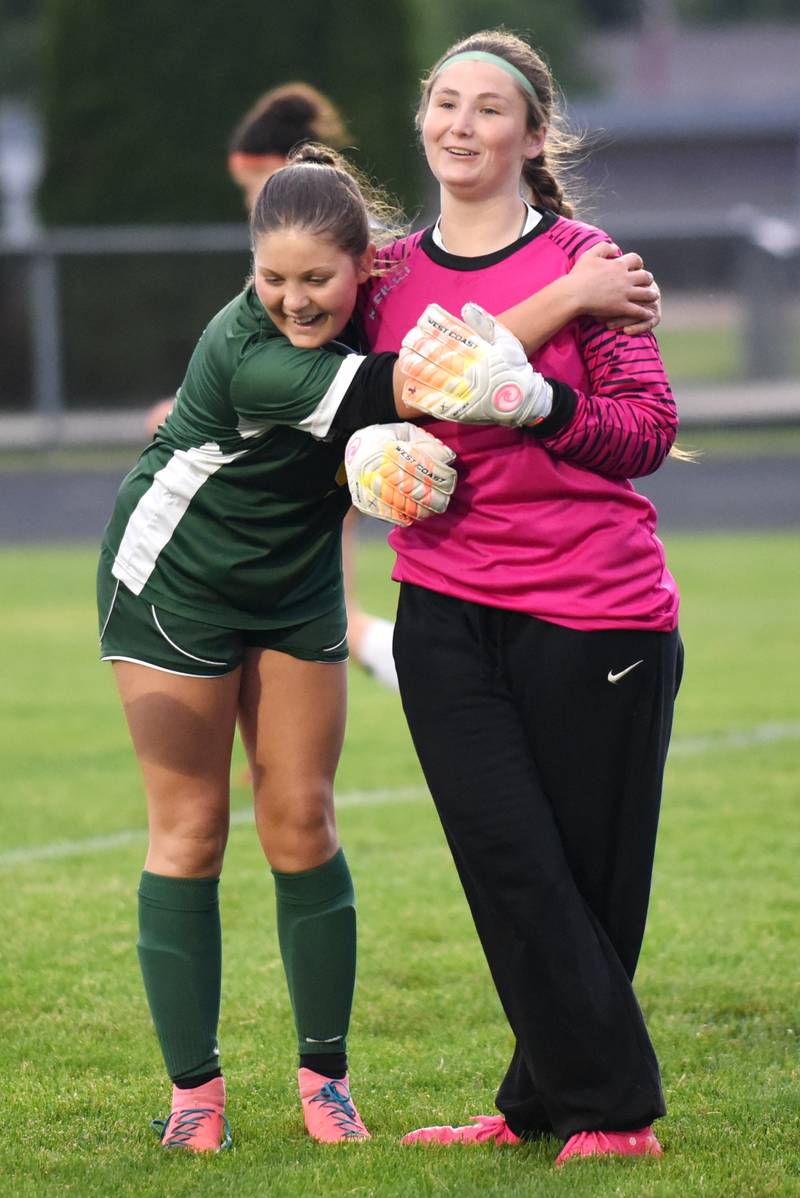 Coal City's Faith Horkavy, left, hugs Coaler goalkeeper Chloe Plueger after one of Plueger's saves in a 4-0 shutout over Beecher in the Class 1A Manteno Regional championship Tuesday, May 20, 2025.