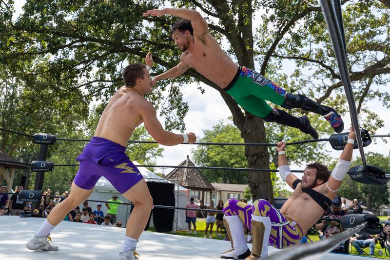(left to right) Hunter Holdcraft looks to reverse Davey Bang's crossbody off the top rope as Gaige Noonan sits in corner at the Taste of the Illinois Valley DreamWave event on Saturday, August 2, 2025 at Centennial Park in Peru.