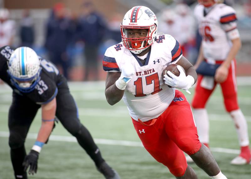 St. Rita's Dj Stewart (17) runs the ball in the second half during their 7A quarterfinal game against St. Charles North in St. Charles on Saturday, Nov. 12, 2022.
