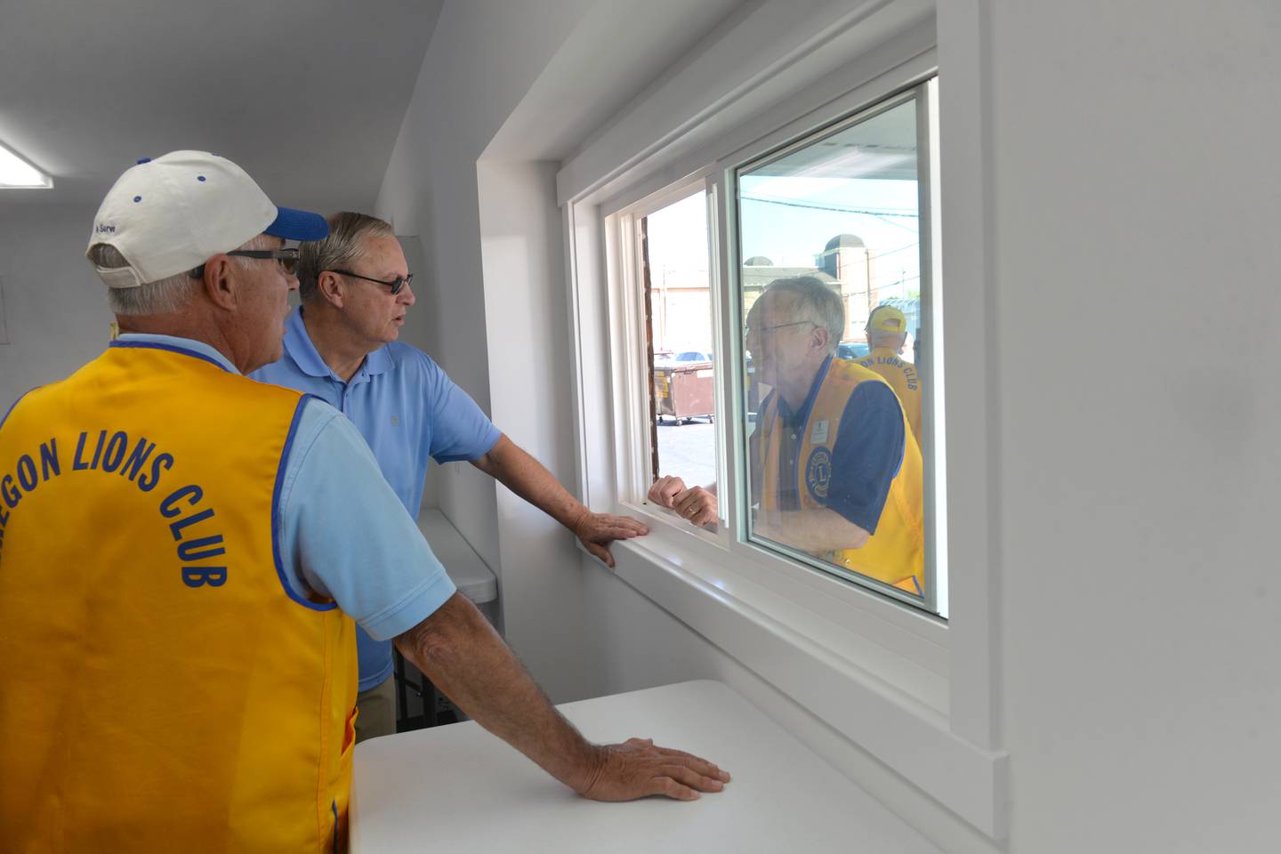 Oregon Lions Grant Afflerbaugh and Tom Champley check out the drive up window at the new Sarah Phelps Community Plaza on Saturday, Sept. 30, 2023. The new plaza will be used in downtown Oregon as a shared venue for community events.
