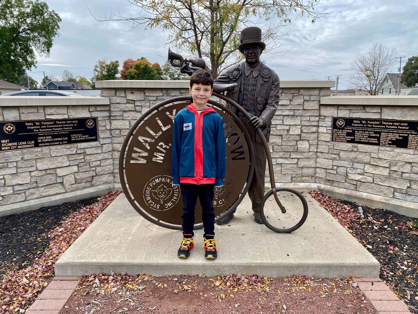 Harrison Rowland, 8, of Sycamore poses in front of the Wally Thurow statue in Sycamore Friday, Oct. 6, 2023. Harrison is the theme contest winner with his theme "Pumpkins of History" for the 2023 Sycamore Pumpkin Festival.